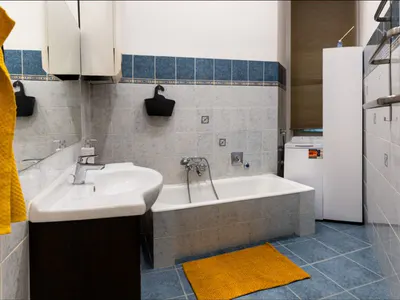 Bathroom with bathtub and vanity at Doma Budapest
