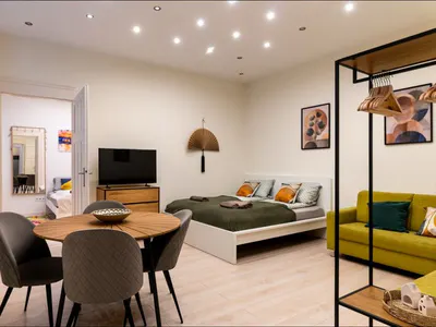 Living room sleeping and dining areas at Doma Budapest