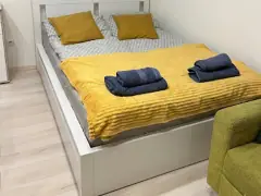 Primary bedroom with mustard bedding