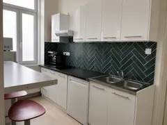 Bright kitchen with white cabinets at Doma Budapest